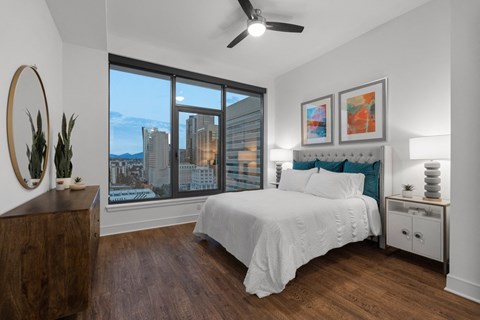 a bedroom with a large bed and a large window